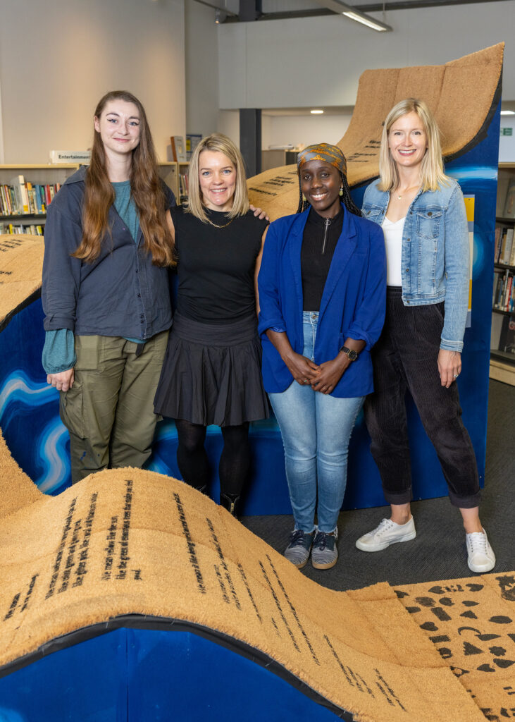Artist Emma Denby, poet Rachel Bower, storyteller Furaha Mussanzi and Bradford Schools of Sanctuary Co-ordinator Kate Hart stand with the 'You're Welcome' sculpture.