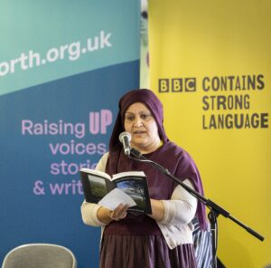 Nabeela Ahmed reads poetry on stage at BBC Contains Strong Language, Bradford 2025